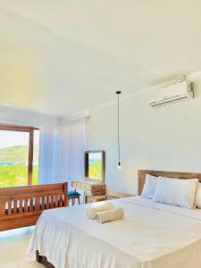 a bedroom with two beds and a television at Garden Hill Views in Kuta Lombok