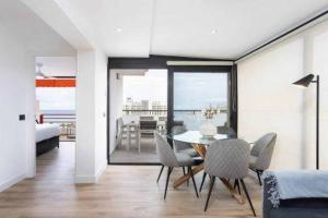 a dining room with a table and chairs and a bedroom at Eden Rentals Olympia Sunny Seaviews in Playa de las Americas