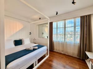 a bedroom with a bed and a large window at Grand Hotel Urban in Antananarivo +67 photos