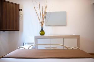 a dining room with a table and a vase at Galati House in Melendugno