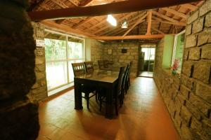 a dining room with a wooden table and chairs at Annmees Freedom Land in Bangalore