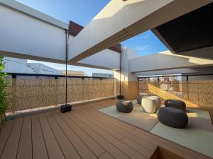 a balcony with two seating areas on a building at KOTI Hakata in Fukuoka