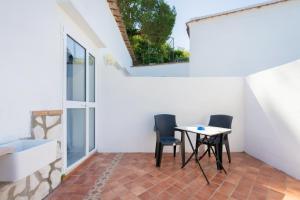 a room with a table and chairs on a patio at Authentic Oasis - Villa La Solara in Anacapri