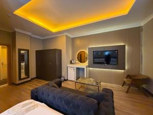 a living room with a couch and a flat screen tv at Royal Nest in Istanbul