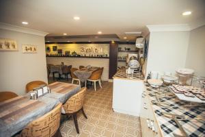 a restaurant with a counter and a dining room at Just Inn Hotel in Istanbul