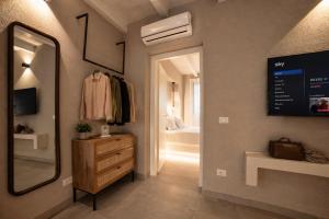 a hallway with a mirror and a dresser and a bathroom at Palermo Inn Boutique Hotel in Palermo