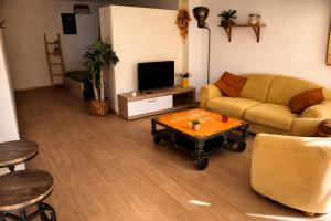 a living room with a couch and a coffee table at Appartement dans le centre médiéval in Hyères