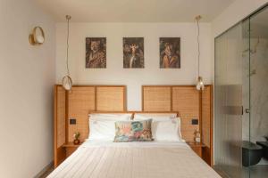 a bedroom with a bed and three pictures on the wall at Dimora Moncher in Montignoso +91 photos