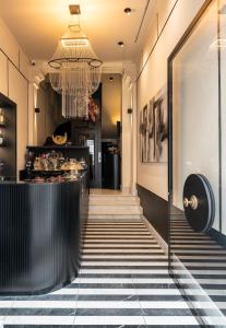 a lobby with a bar and a chandelier at Sparano Palace - Luxury Maison in Bari