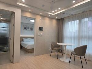 a room with a bed and a table and chairs at TRAVELUS Myeongdong 트래블어스 명동 in Seoul