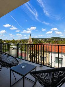 a balcony with two chairs and a table at Pensiunea Brici Junior in Cluj-Napoca