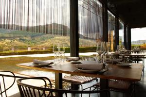 a restaurant with tables and chairs and a large window at Belle Torre Mayorazgo Boutique Hotel in Villatoro