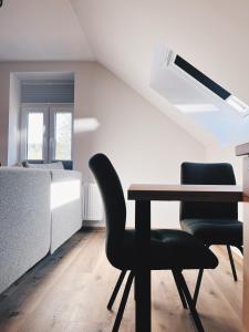 a bedroom with a table and two chairs and a bed at Alter Bahnhof Sichtigvor in Warstein