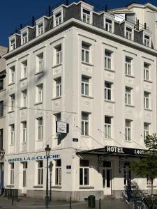 a large white building with a hotel at Hotel La Grande Cloche in Brussels