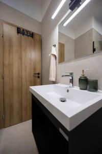 a bathroom with a white sink and a wooden door at Lume Capi in Labin +41 photos