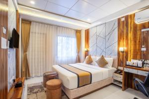 a hotel room with a bed and a television at Accom Hotel in Ilām +44 photos