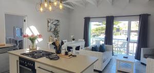 a kitchen and living room with a view of a patio at Point Village Hotel and Self Catering in Mossel Bay