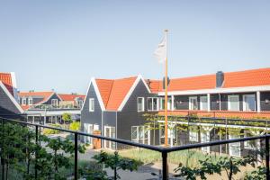 a rendering of a school building with red roof at Hotel De Zeeuwse Kust (family only) in Renesse