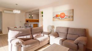 a living room with two couches and a couch and a table at Villa Infinity Torrox by Ruralidays in Torrox