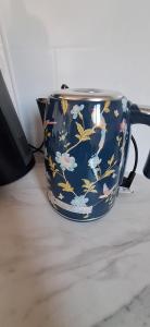a blue vase with flowers on it sitting on a table at Villa De Alexiano in Alixan