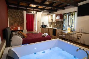 a bathroom with a tub in the middle of a room at Golden House in Bracciano