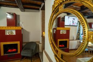 a mirror and a chair in a living room at Golden House in Bracciano