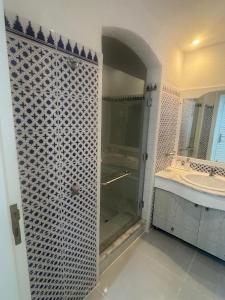 a bathroom with a walk in shower and a sink at MDS Coral Bay Pearl Sea View Resort in Sharm El Sheikh +27 photos