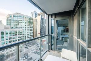 a balcony with a view of a city at Stylish 1BR plus Den Suite with Parking, Sleeps 4) in Toronto