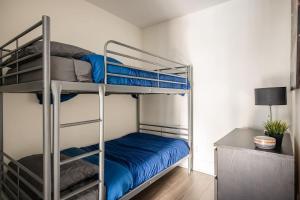 a bedroom with two bunk beds with blue sheets at Stylish 1BR plus Den Suite with Parking, Sleeps 4) in Toronto