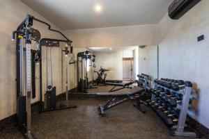 a gym with several treadmills and machines in a room at Luxury Beachfront 3BR Appartment in Tulum