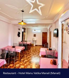 a dining room with pink tables and chairs at Hotel Royal Selection in Manāli