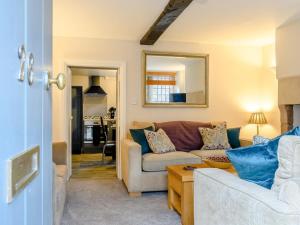 a living room with a couch and a mirror at 3 Bed in Matlock oc-78591 in Cromford
