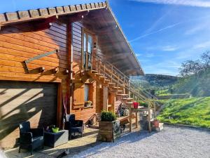 a wooden house with a staircase and a patio at studio in Puessans
