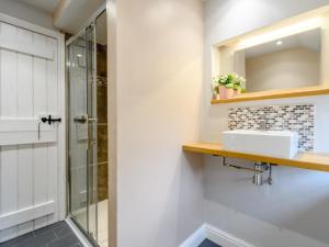 a bathroom with a sink and a shower at 3 Bed in Matlock oc-78591 in Cromford +30 photos