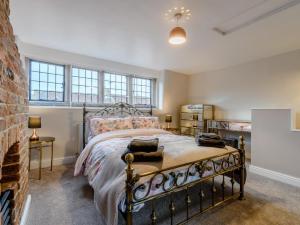 a bedroom with a bed and a brick wall at 3 Bed in Matlock oc-78591 in Cromford
