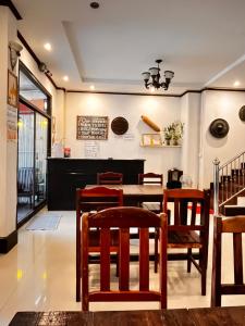 a dining room with a table and chairs at Camellia Hotel in Vang Vieng