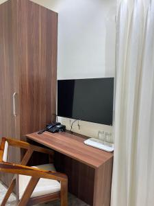 a wooden desk with a television on top of it at Hotel Ashoka Resort in Ellora +22 photos