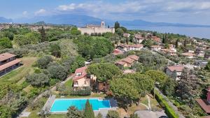 an aerial view of a house with a swimming pool at Olive Garden Garda - pool & view in Moniga