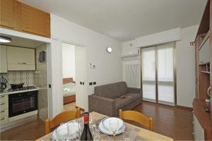 a kitchen and a living room with a couch and a table at Casa vacanza Iris in Toscolano Maderno