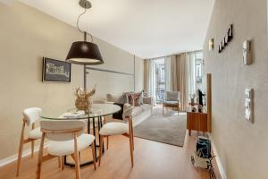 a living room and dining room with a table and chairs at Casas do Porto - Ribeira Apartments in Porto