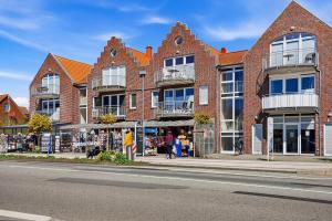 a group of brick buildings on a city street at Möwennest in Norddeich