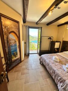 a bedroom with a bed and a view of the ocean at B&B La Bastia in Scilla