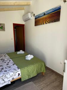 a bedroom with a bed with towels on it at Casa Borgo in Bale