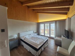 a bedroom with a bed and a flat screen tv at Residence Edelweiss No Stress by Eva in Bellwald +63 photos