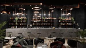 a restaurant with a bar with tables and chairs at IDEA Collection by GINO Hotels in Tbilisi City