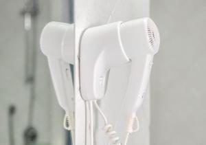 a row of white hair dryers hanging on a wall at Authentic Oasis - Villa La Solara in Anacapri