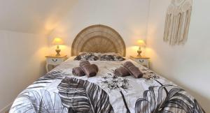 a bedroom with a large bed with pillows on it at Penty horizon de Brocéliande in Augan