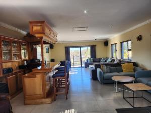 a living room with a blue couch and a kitchen at Ntobongwana in Pinetown