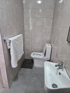 a bathroom with a toilet and a sink at Ntobongwana in Pinetown +27 photos