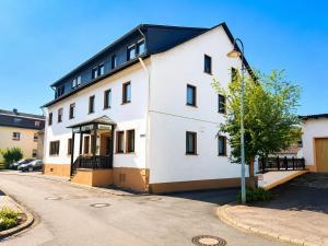 a white building with a black roof at Gasthaus Bidinger in Schoden